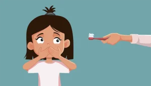 The girl refuses to brush her teeth, but she gets a bad breath